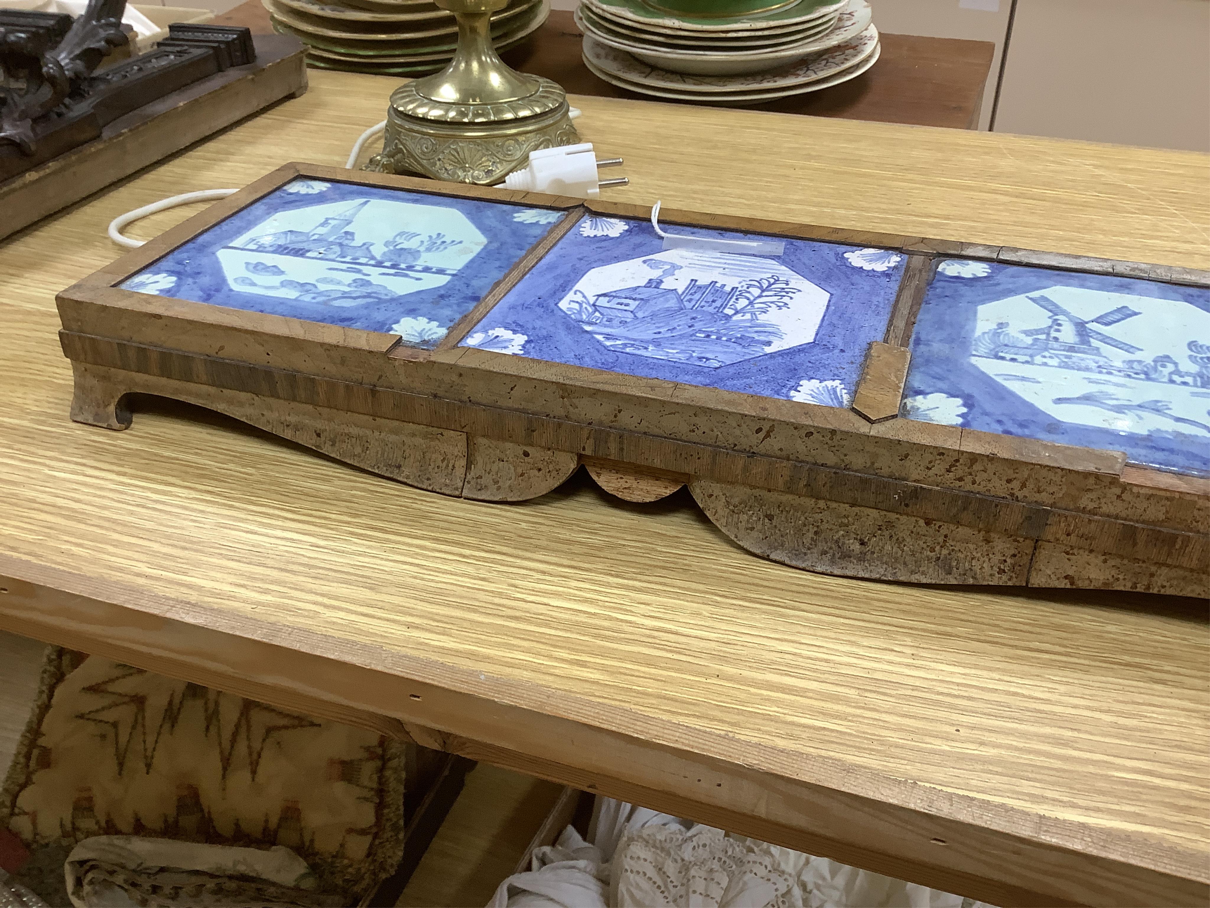 A 19th century Delft tile inset walnut stand, 49cm wide. Condition - poor
